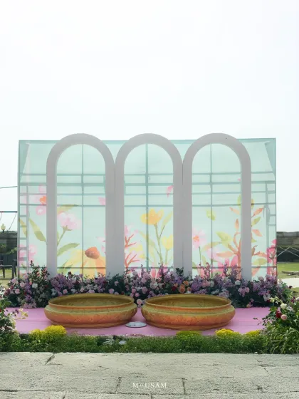 The serene and beautiful setup for a modern Haldi ceremony. The pastel arches and floral arrangements create a picturesque backdrop, proving that the decor is the silent character that helps tell the story of your day.