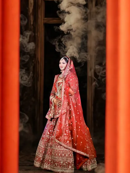 A stunning bridal portrait with a cinematic feel. The bride is framed by orange pillars, with smoke creating a dreamy, ethereal atmosphere around her.