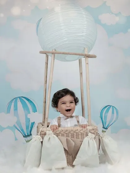 Up, up, and away. Our hot air balloon theme sets the stage for a whimsical adventure, creating magical portraits of your little one floating amongst the clouds in our studio.