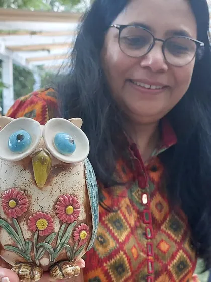 It brings me so much joy to see my creations, like this floral owl vase, find a loving home. This happy customer picked it up at the Ahmedabad Potter's Market.