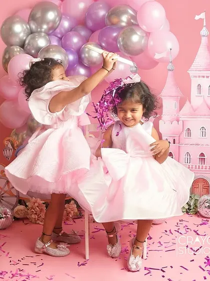 A playful moment between the princess sisters, showering each other with confetti. Pure, chaotic joy.