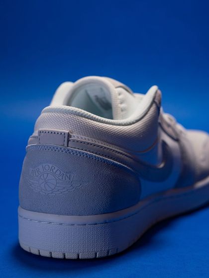 A shot of the heel of the Jordan 1 Low 'Paris', showing the debossed Air Jordan Wings logo for a subtle, premium finish.