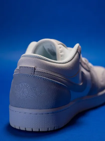 A shot of the heel of the Jordan 1 Low 'Paris', showing the debossed Air Jordan Wings logo for a subtle, premium finish.