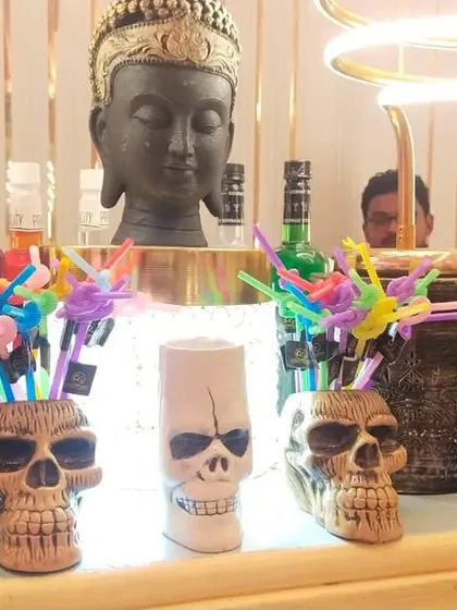 A bar setup of the day featuring skull-themed glassware and a Buddha head centerpiece. We can mix and match styles to create a truly unique look.