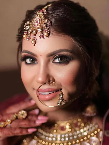 A captivating close-up of the bride's makeup. Her beautiful eyes are enhanced with liner and lashes, and the skin has a radiant, airbrushed finish that is perfect for wedding photography.