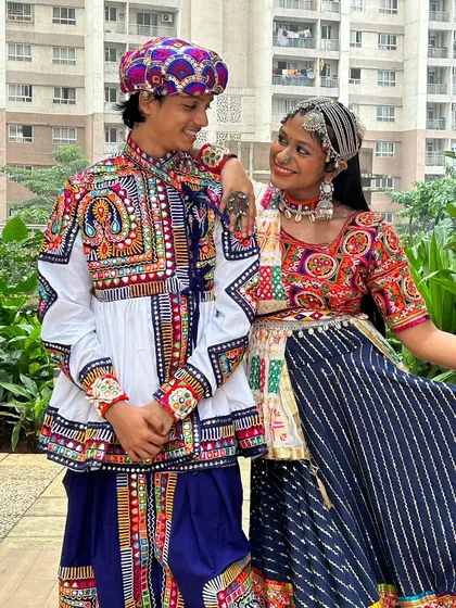 A sweet moment between a couple dressed in my traditional Garba attire. His colorful Kedia and her intricately designed chaniya choli are a perfect match.