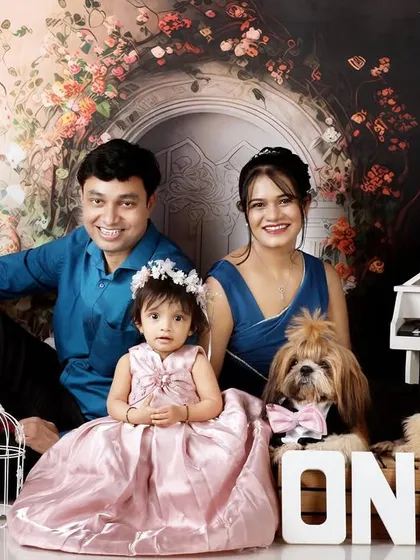 A complete family portrait, including their pet dog, for a memorable and elegant first birthday celebration.