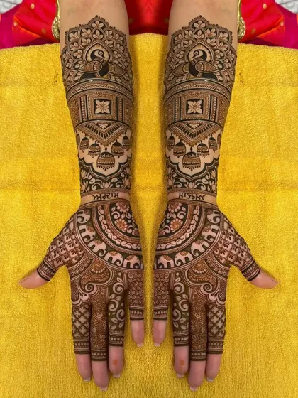 A personalized bridal design with the couple's names, surrounded by peacocks and other traditional motifs.