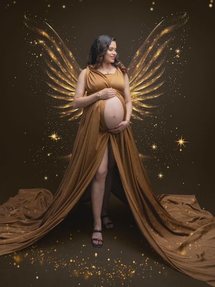 Every mom-to-be carries the glow of something magical. This portrait brings that magic to life with shimmering angel wings and an ethereal light.