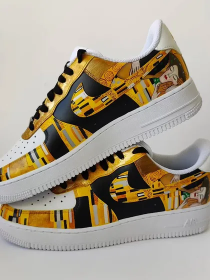 This angle shows the other side of the Klimt sneakers, where the golden cloak continues to wrap around the shoe.