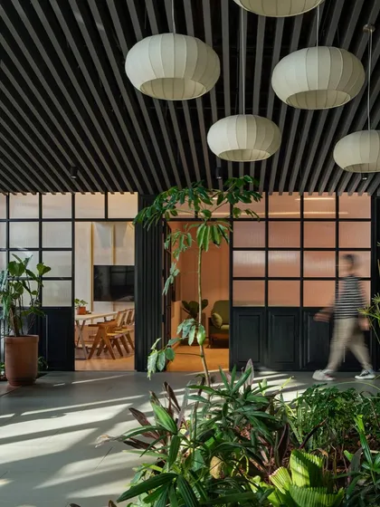 In this sales lounge, I used biophilic design to create a tranquil and engaging environment. An indoor garden bed acts as a natural divider, while frosted glass partitions and soft, lantern-like lighting create a sense of calm movement and connection to nature, even within a corporate setting.