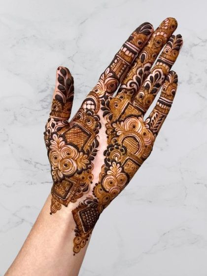 An intricate Indo-Western design on the back of the hand, combining traditional motifs with modern composition for a stylish look.