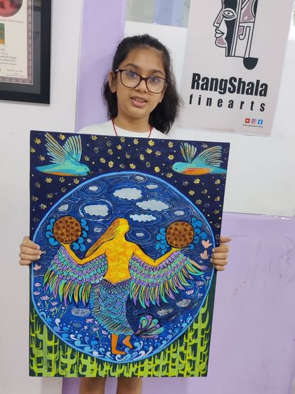 A young artist proudly shows off her imaginative and colorful mermaid painting. We help children bring their unique ideas to life on canvas.