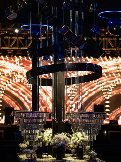 A modern, sculptural bar centerpiece with hanging crystals. This unique installation adds an artistic and futuristic touch to the cocktail party decor.