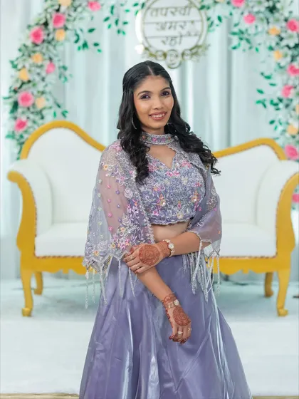 This full-length shot shows how a soft glam look can complete an entire outfit. The makeup is elegant and understated, allowing her beautiful lavender lehenga to shine.