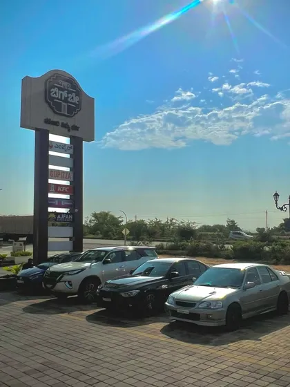 A sunny day shot of our brand pylon and parking area, welcoming the summer and giving you more reasons to stop by the Bay.