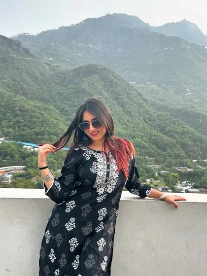 A playful pose in the kurta, with the green hills behind me. This blends traditional Indian fashion with the beauty of nature.