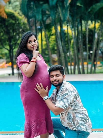 A candid and playful moment during a poolside maternity shoot. The genuine interaction and loving gesture from the dad-to-be make this photo truly special.