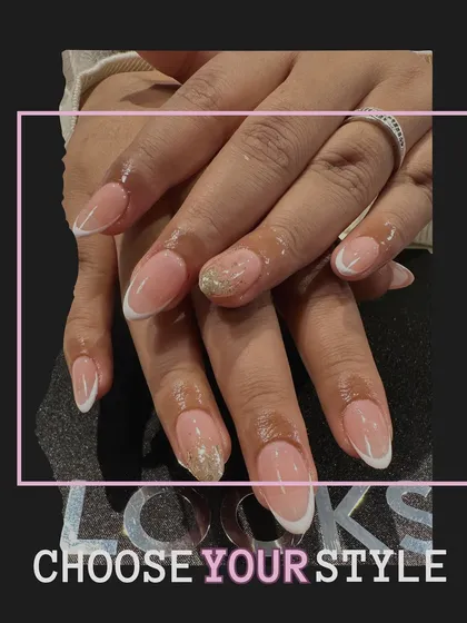 Another view of this popular French manicure with a glitter accent. It shows how the light catches the sparkle, making it a great choice for both day and night.