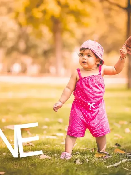 Capturing those first wobbly steps is pure gold. For this outdoor session, I documented a little girl celebrating her first year by exploring a sunlit park while holding her mother's hand, a beautiful story of growth and connection.
