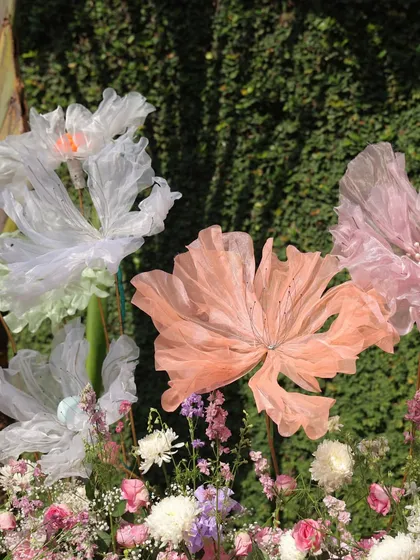 A close-up of the handcrafted, oversized paper flowers used in the carnival decor. These artistic details add a touch of whimsy and uniqueness to the overall design.