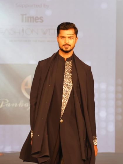 A powerful look for designer Pankaj Soni at Mysore Fashion Week, featuring layered ethnic wear and distinctive facial makeup.