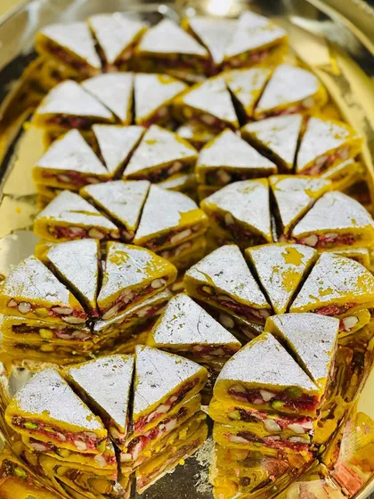A close-up of our signature Dryfruit Sandwich. This unique sweet features layers of nuts and dried fruits, making it a memorable treat for welcoming guests or adding a special touch to your gift hampers.