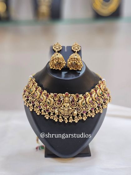 Unique caption for media id 100 describing the specific jewellery and look.