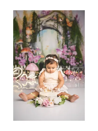 A fairy's first cake smash! This enchanted forest theme, complete with mushrooms and butterflies, creates a magical setting for a first birthday.