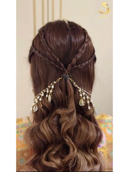 A close-up of the criss-cross braids and the unique shell hair accessory.