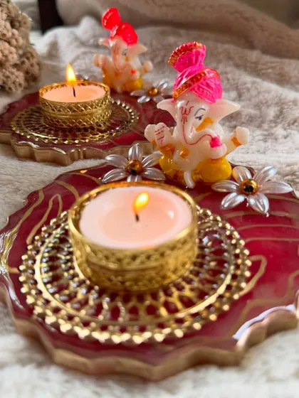 Perfect for adding a divine touch to your home, this handcrafted resin diya features a charming Ganesha idol. The rich red and gold design brings warmth and positivity, making it ideal for festive decor or as a thoughtful housewarming gift.