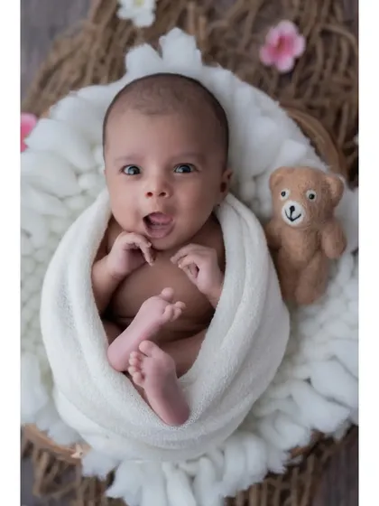 Hello, world! Not all magical moments happen during sleep. I love capturing the bright, curious eyes and expressive faces of awake newborns. This little one, nestled in a soft basket, seems ready to take on the world.