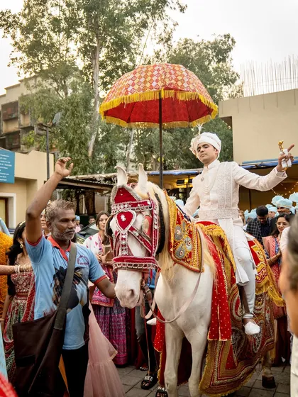 The groom, looking regal on a beautifully decorated horse, is ready for his baarat. I coordinate all the traditional elements to ensure a majestic and picture-perfect procession.