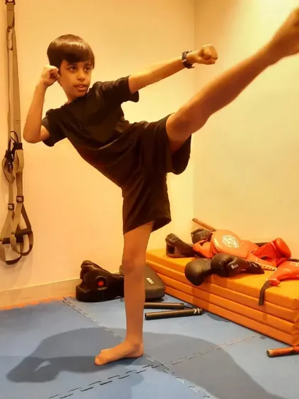 A clean, powerful side kick from a young martial artist. This pose demonstrates great form, balance, and active flexibility, which are core components of our Kung Fu training for kids.
