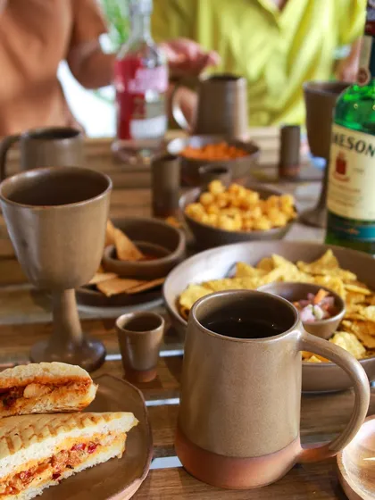 A full table setting from the 'Moments Together' collection, complete with goblets, mugs, and shot glasses, perfect for a fun night with friends.