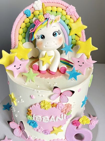 A close-up of the adorable, handcrafted unicorn topper, holding a little star.