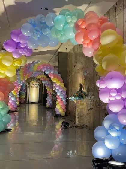 Another view of the pastel rainbow balloon tunnel, showing the scale and immersive effect of the decoration.