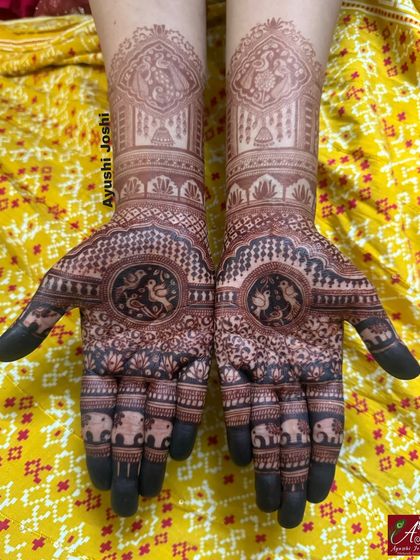 The beautiful dark stain of a Roka mehendi. This design features love birds in the center, surrounded by elephants and traditional patterns.