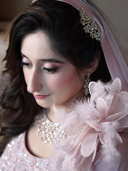 A profile view of Aaliyah's soft and sophisticated engagement makeup. The blush tones and shimmering eyes are perfectly balanced, creating a look that is both delicate and memorable.