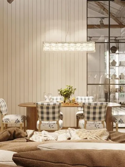 A cozy dining nook vignette within the store. The combination of patterned chairs, a rustic wood table, and glass partitions creates the feeling of stepping into a private dining room.