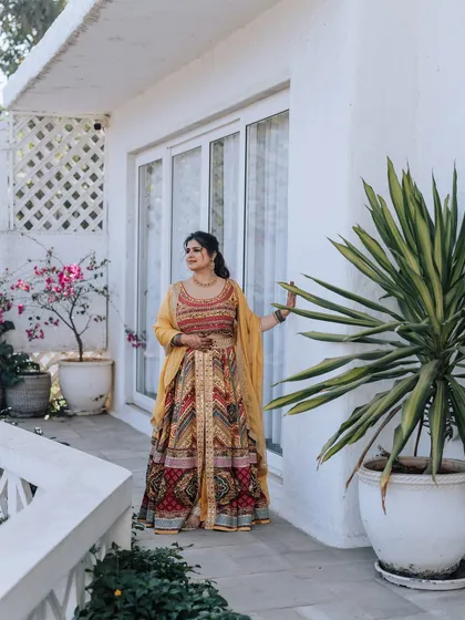 The bride looking radiant against a white bougainvillea-laden wall. I scout for the best photo spots at the venue to ensure the couple gets stunning portraits.