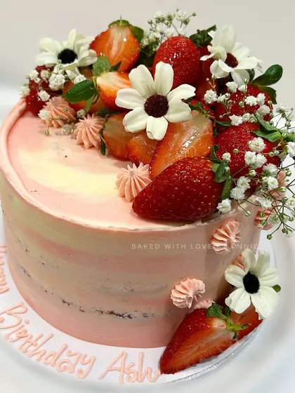 A custom Dark Chocolate Strawberry Cake I created for a special birthday. It features layers of moist chocolate sponge and creamy ganache, finished with soft pink vanilla buttercream and fresh strawberries.
