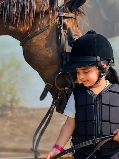 A close-up of a young rider and her horse, sharing a quiet moment of understanding.
