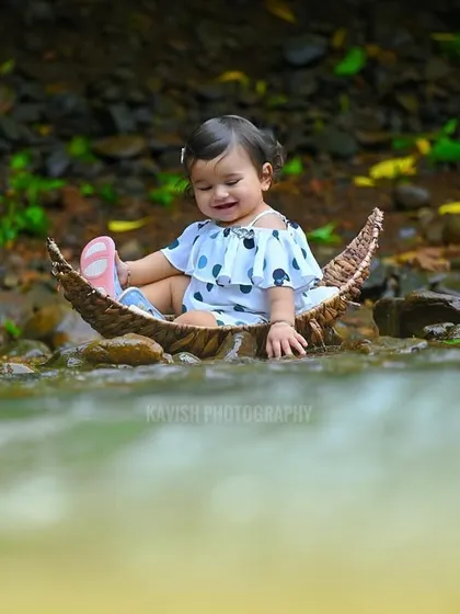 A candid moment of the baby playing with her shoe in the boat, full of innocent charm.