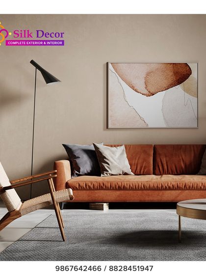 A modern living room setting featuring our custom rust-colored sofa. The clean lines and plush fabric provide a warm and inviting focal point, paired here with a woven wood accent chair to create a balanced, contemporary space.