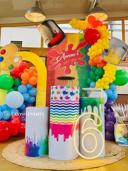 Let's get creative with a unique art studio theme. I use bright, splattered colors, giant paint bucket props, and a custom neon sign to design a space that inspires fun and imagination for your little artist.