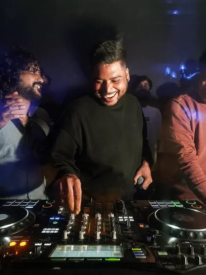 Good vibes only. A candid moment of laughter and fun in the DJ booth with friends.