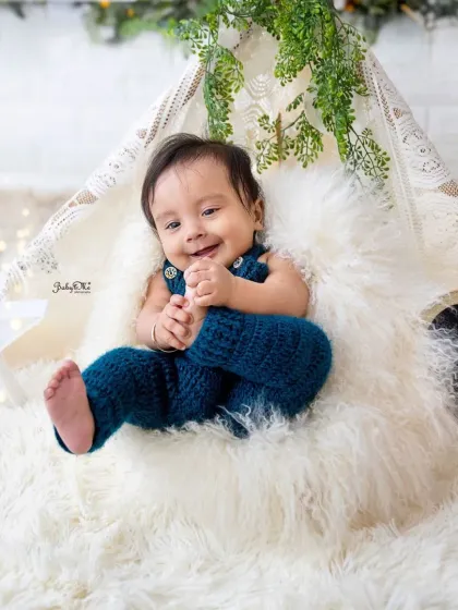Halfway to one and full of smiles. This shot, with him grabbing his feet, perfectly captures the playful nature of a six-month-old.