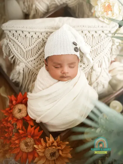 The same newborn now peacefully asleep in a boho-themed setup with macrame and sunflowers. We patiently wait for the perfect moments to get a variety of shots.