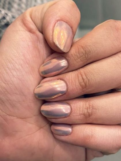 A stunning rose gold chrome finish. This polish gives a liquid metal, mirror-like shine that is incredibly trendy and sophisticated.